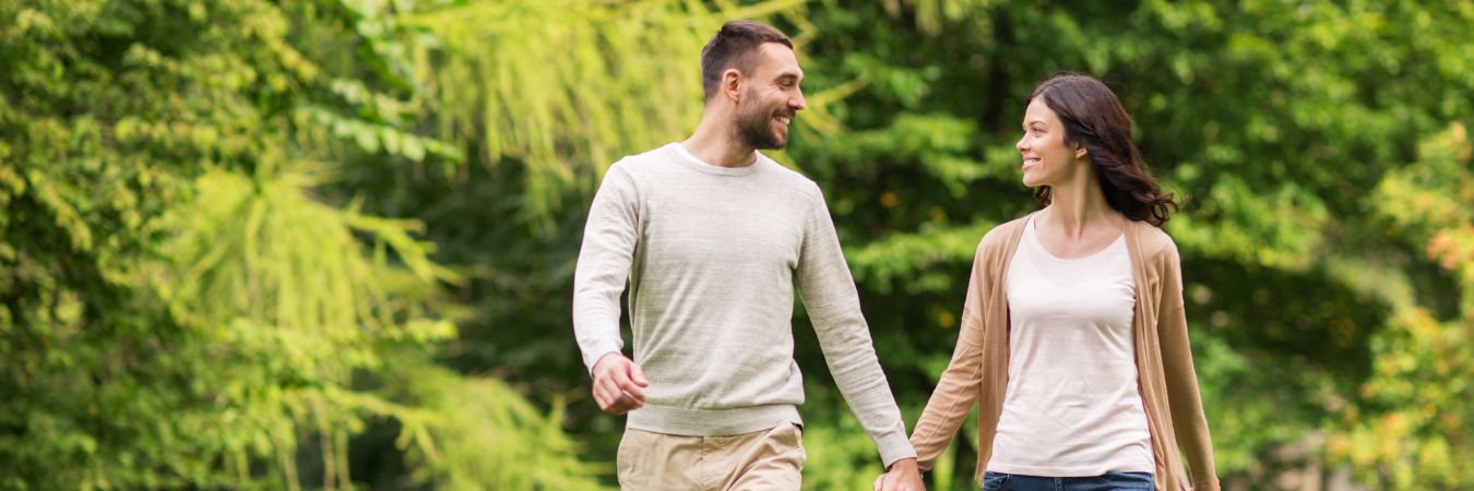  A couple walking hand in hand at a park during summer season enjoying life after rehab in Freehold